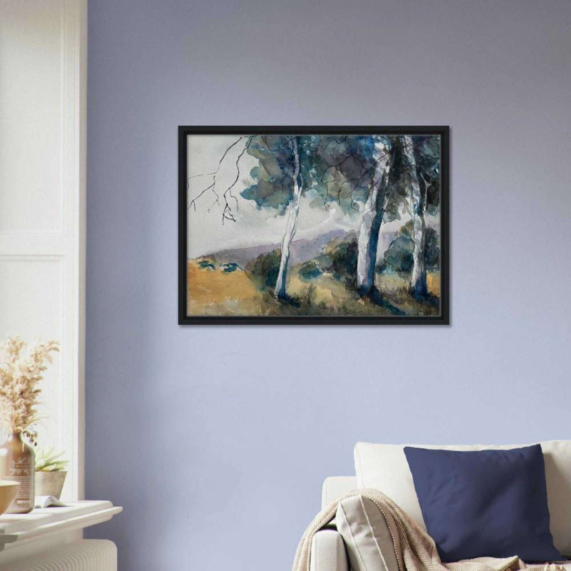 Australian watercolor landscape wall art print in a black frame, featuring gum trees and distant hills, displayed in a living room setting.