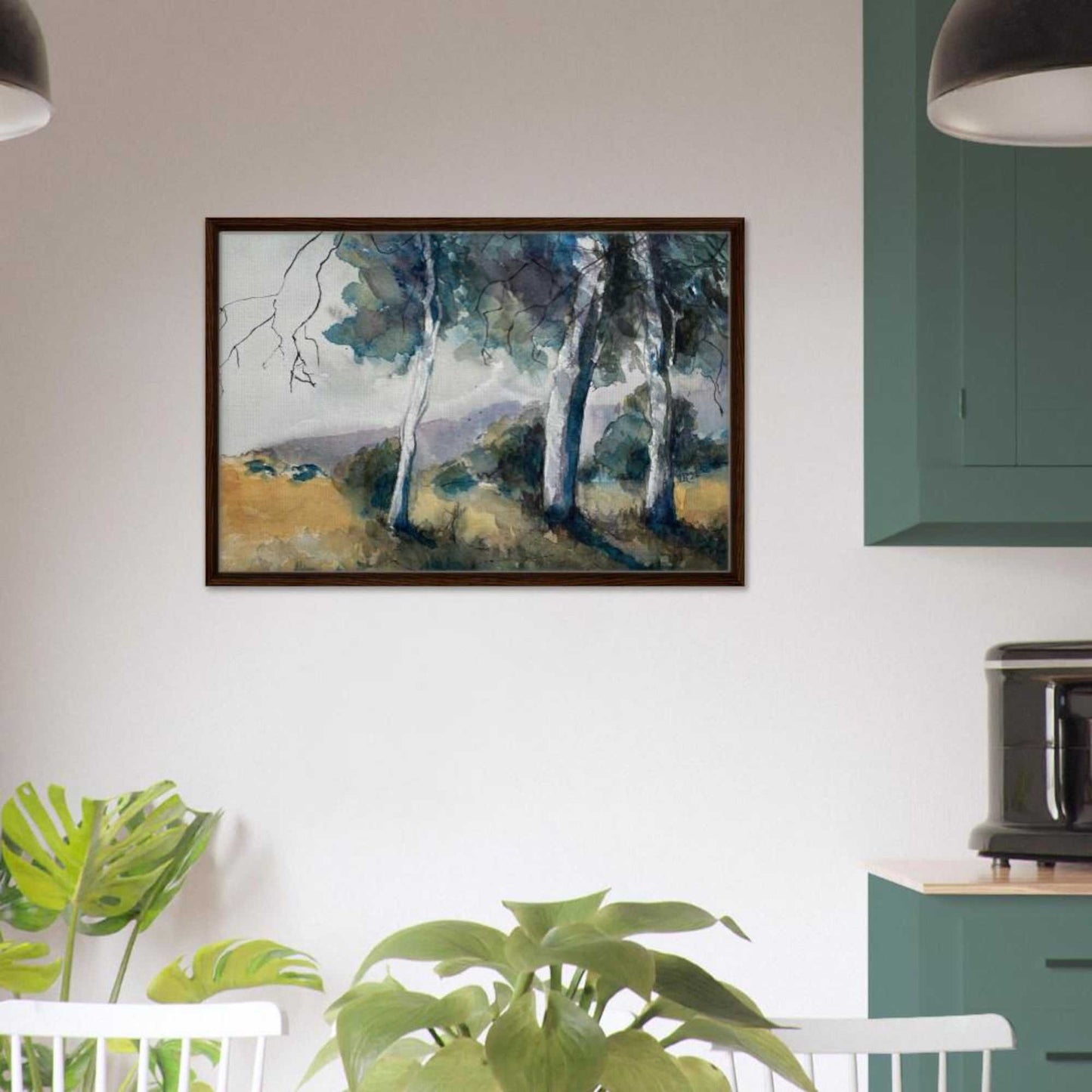 Australian watercolor landscape wall art print in a dark brown frame, featuring gum trees and hills, displayed above a modern interior with plants.